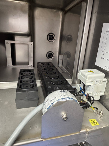 Electrical panel with multiple outlets and wiring inside a metallic enclosure