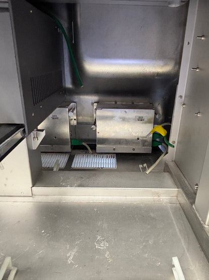Metallic interior of a vehicle with visible wear and cleaning supplies.