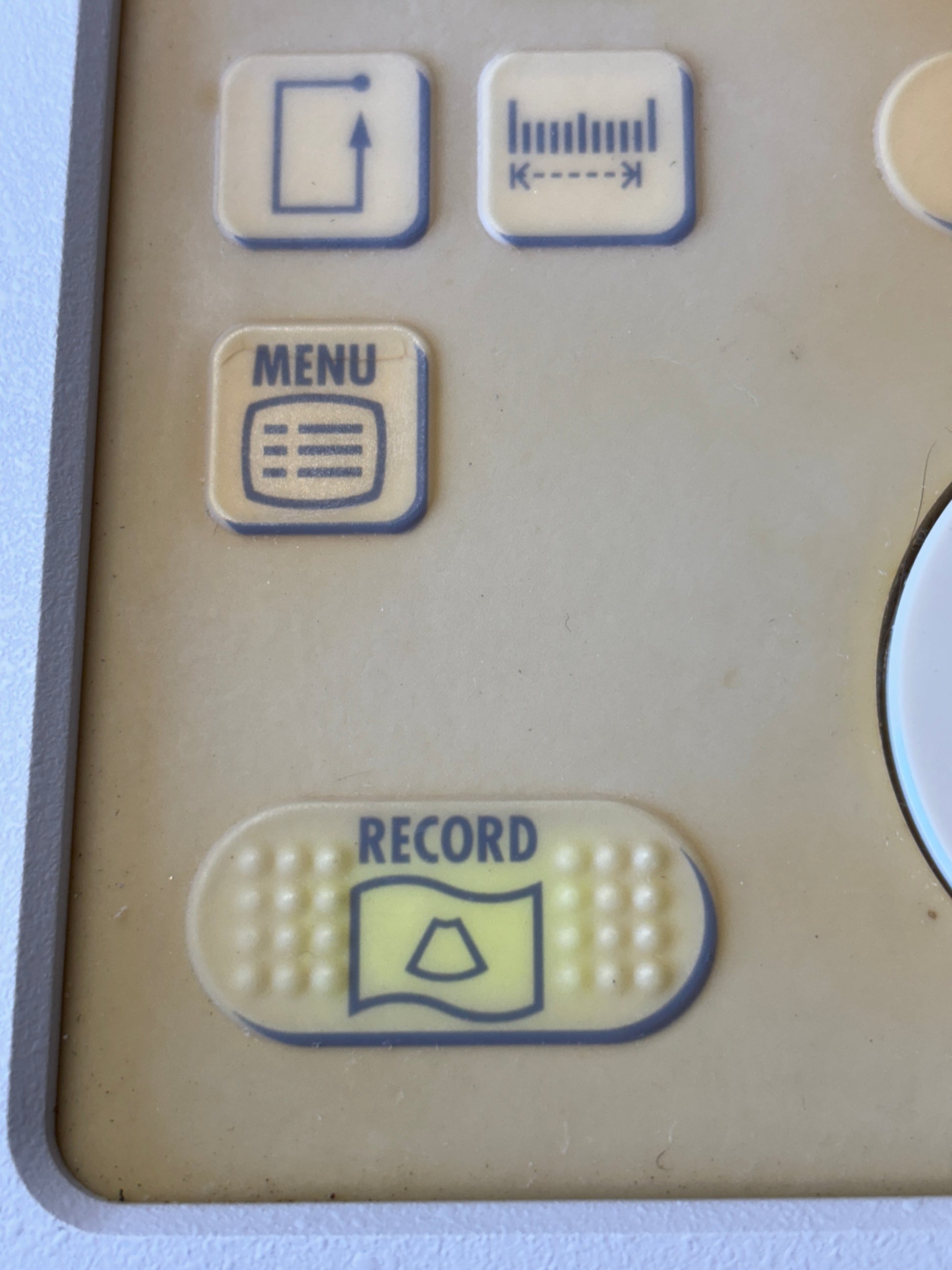 Control panel with buttons labeled 'Record' and others on a beige background