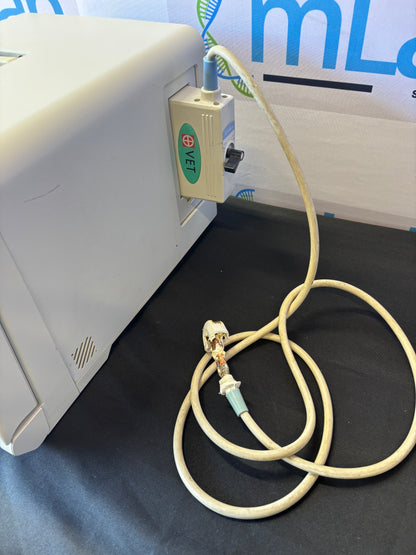 Medical device with a cable on a dark surface, featuring a brand logo.