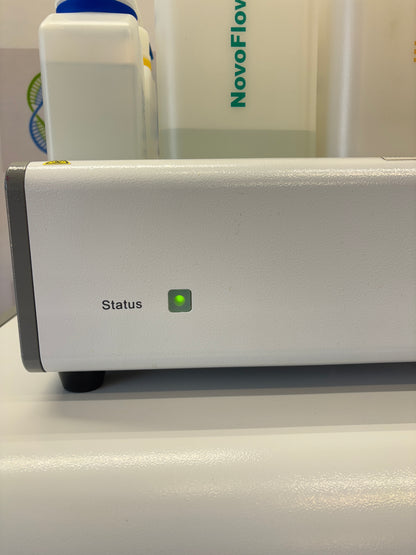 White electronic device with green indicator light on a white background