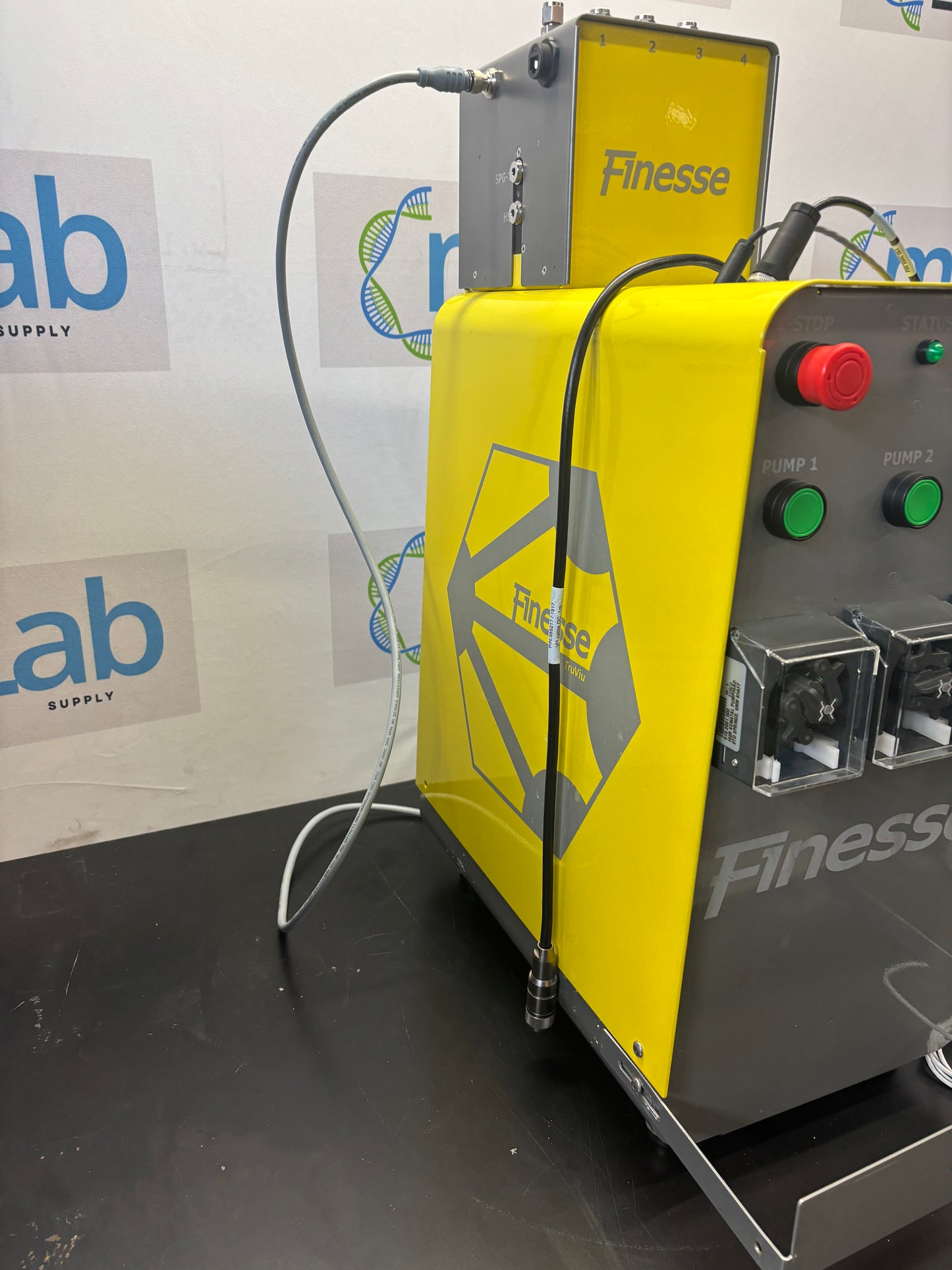 Yellow and black machine with control panel on a white surface with logos.