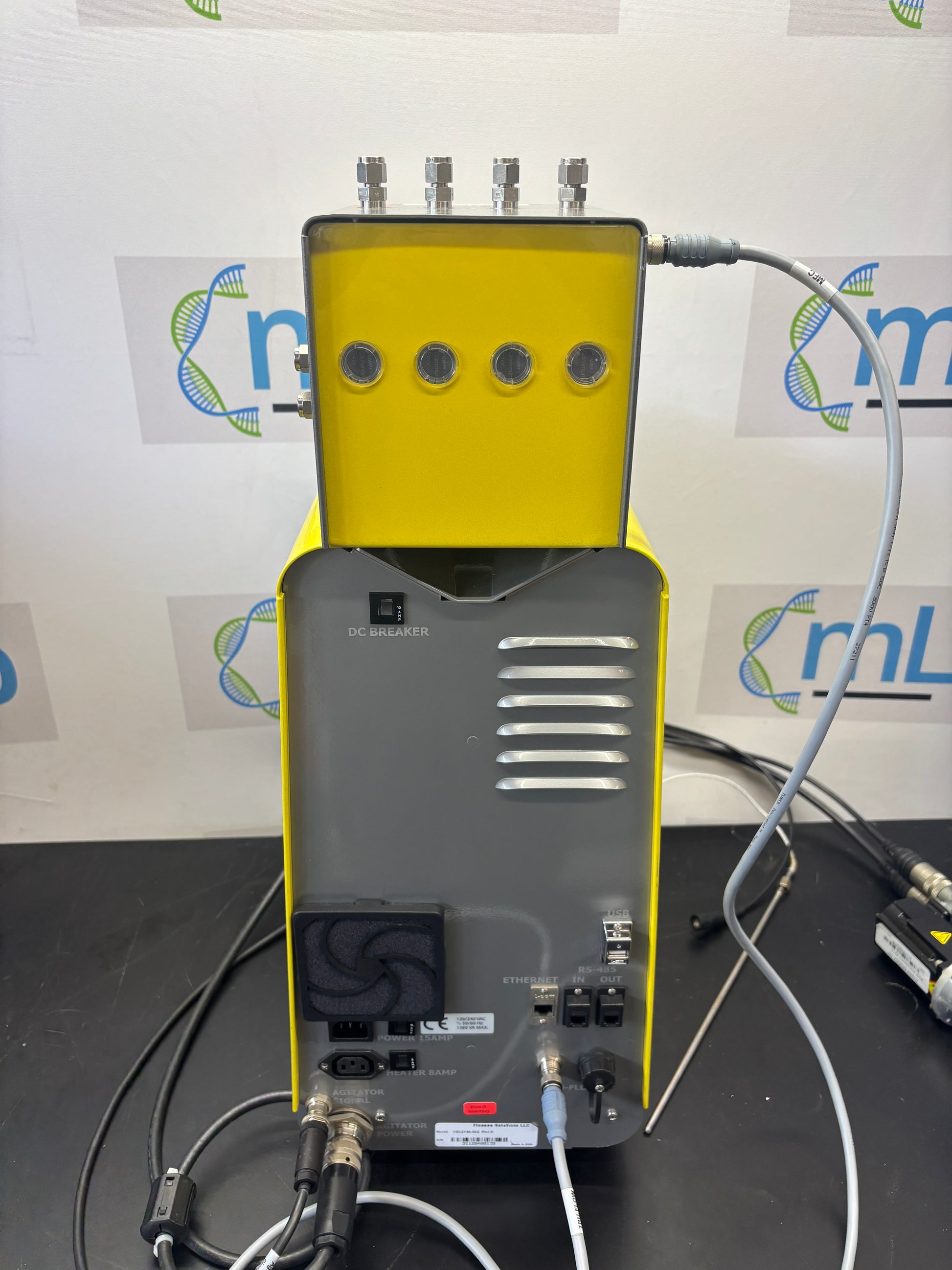 Yellow and black electronic device with cables on a white background