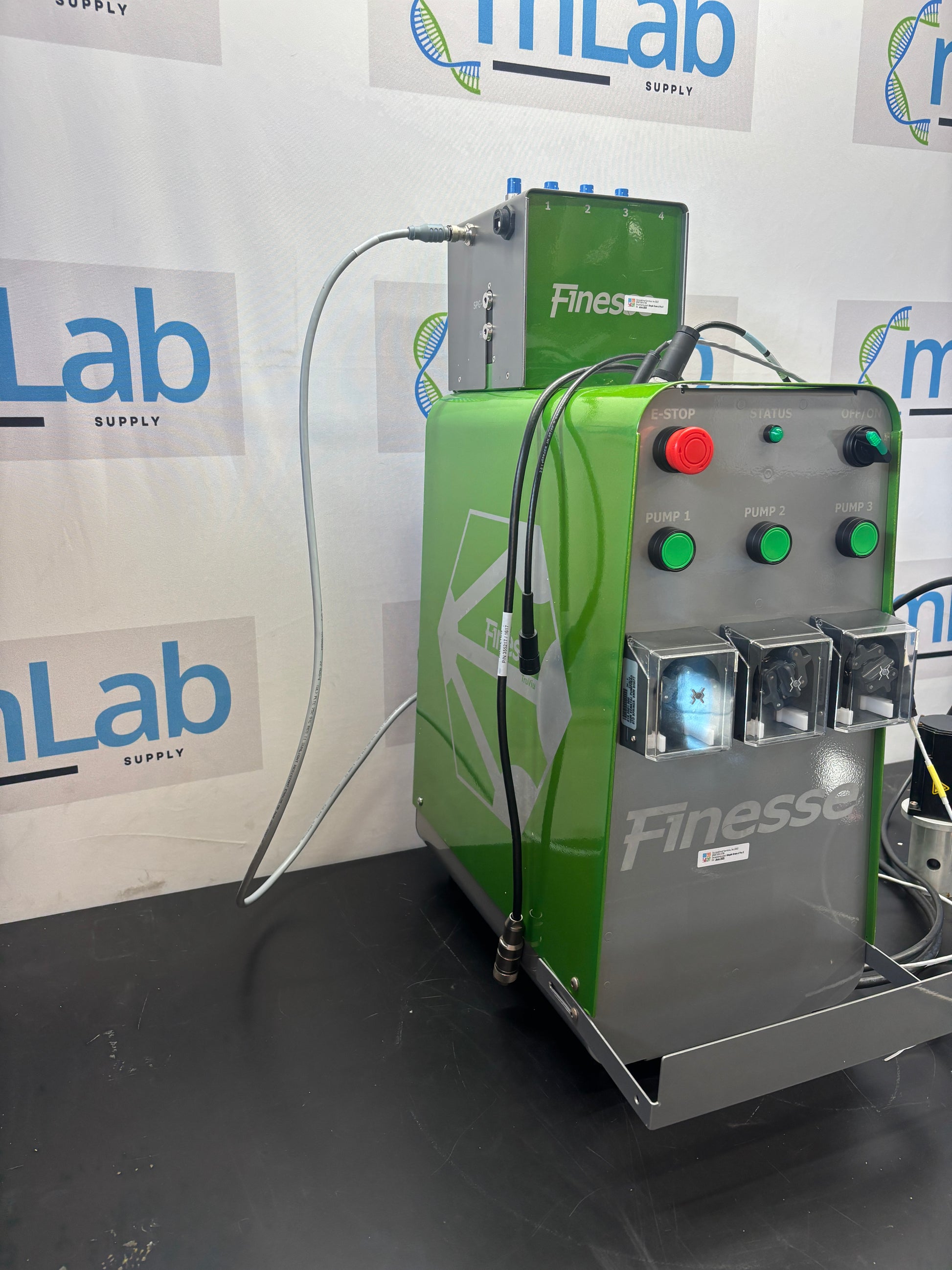Green machine with control panel on a surface with 'Lab' branding