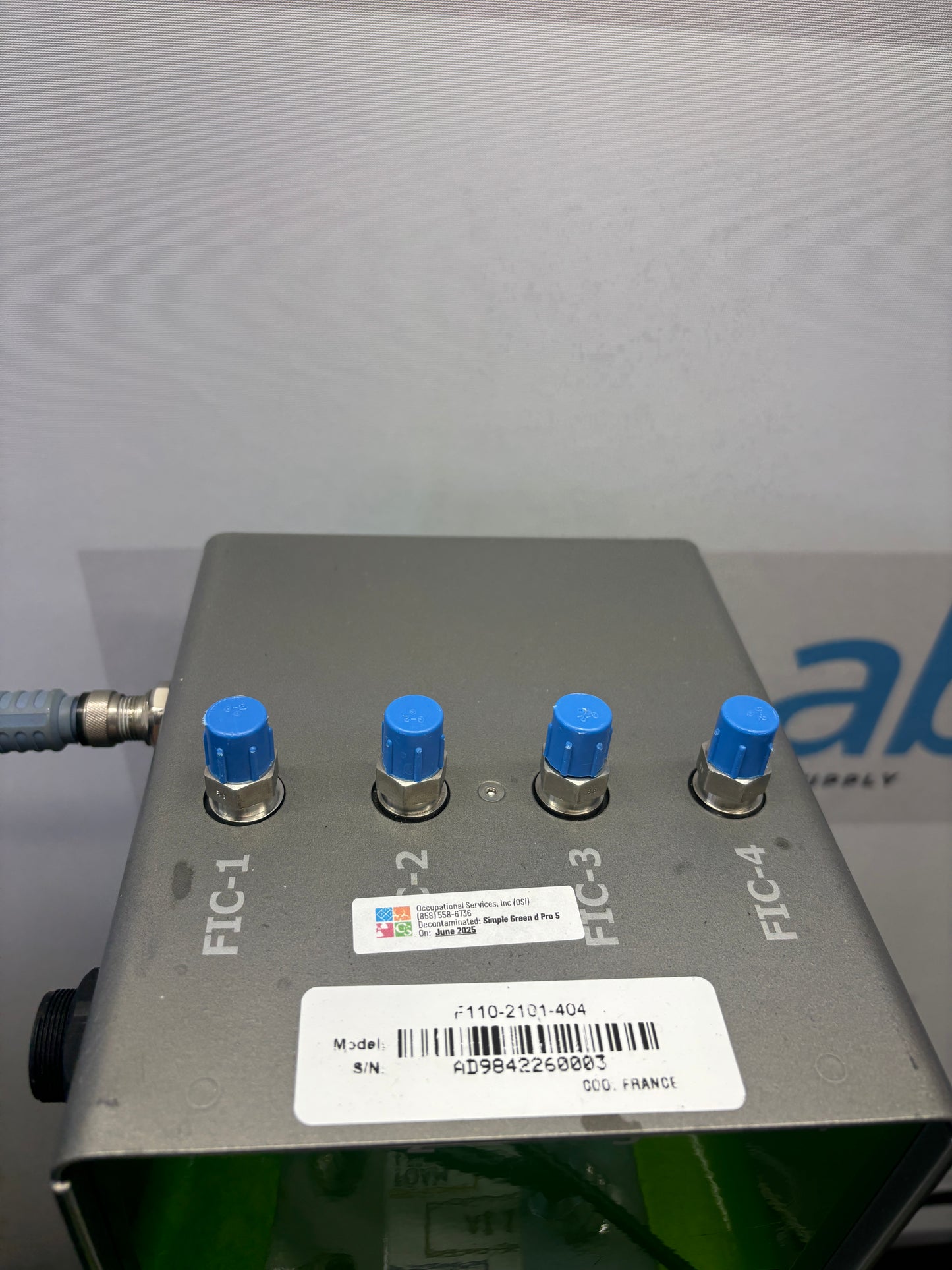 Control panel with blue knobs and a label on a gray background