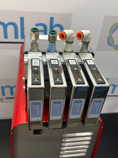 Stack of electronic components on a red stand with a blurred background