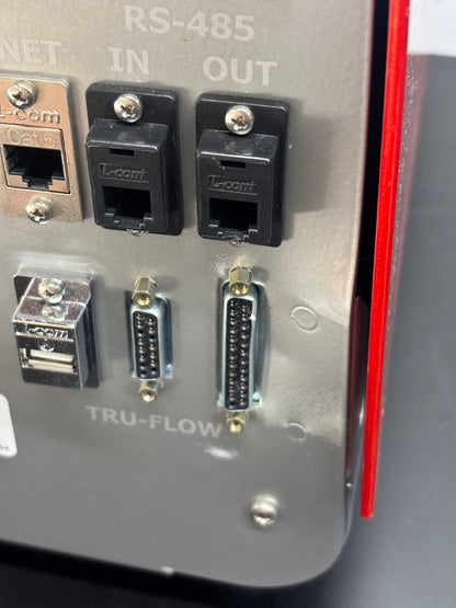 Close-up of electronic connectors on a metal surface with 'TRU-FLOW' branding.