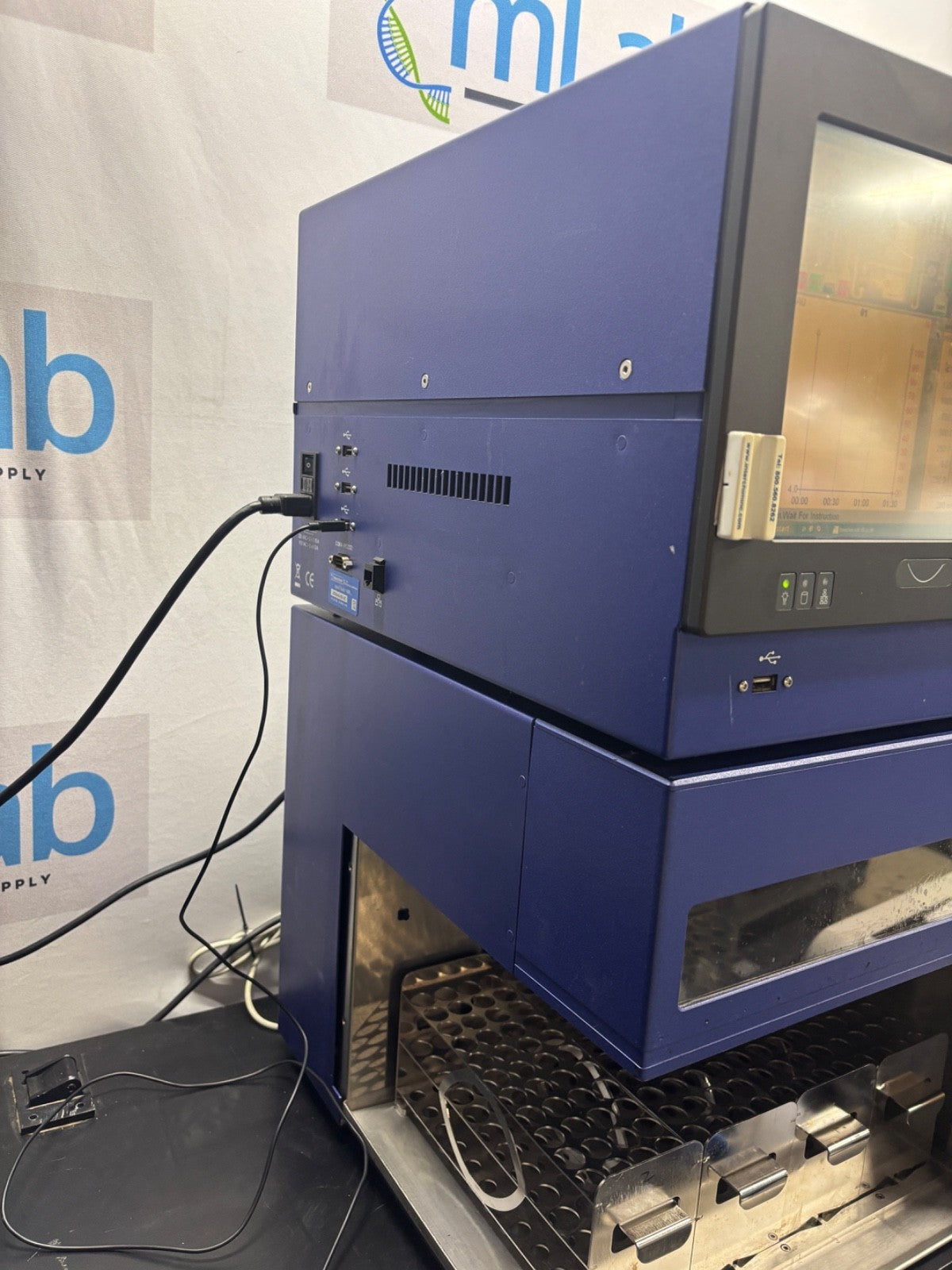 Blue industrial machine with visible branding in the background