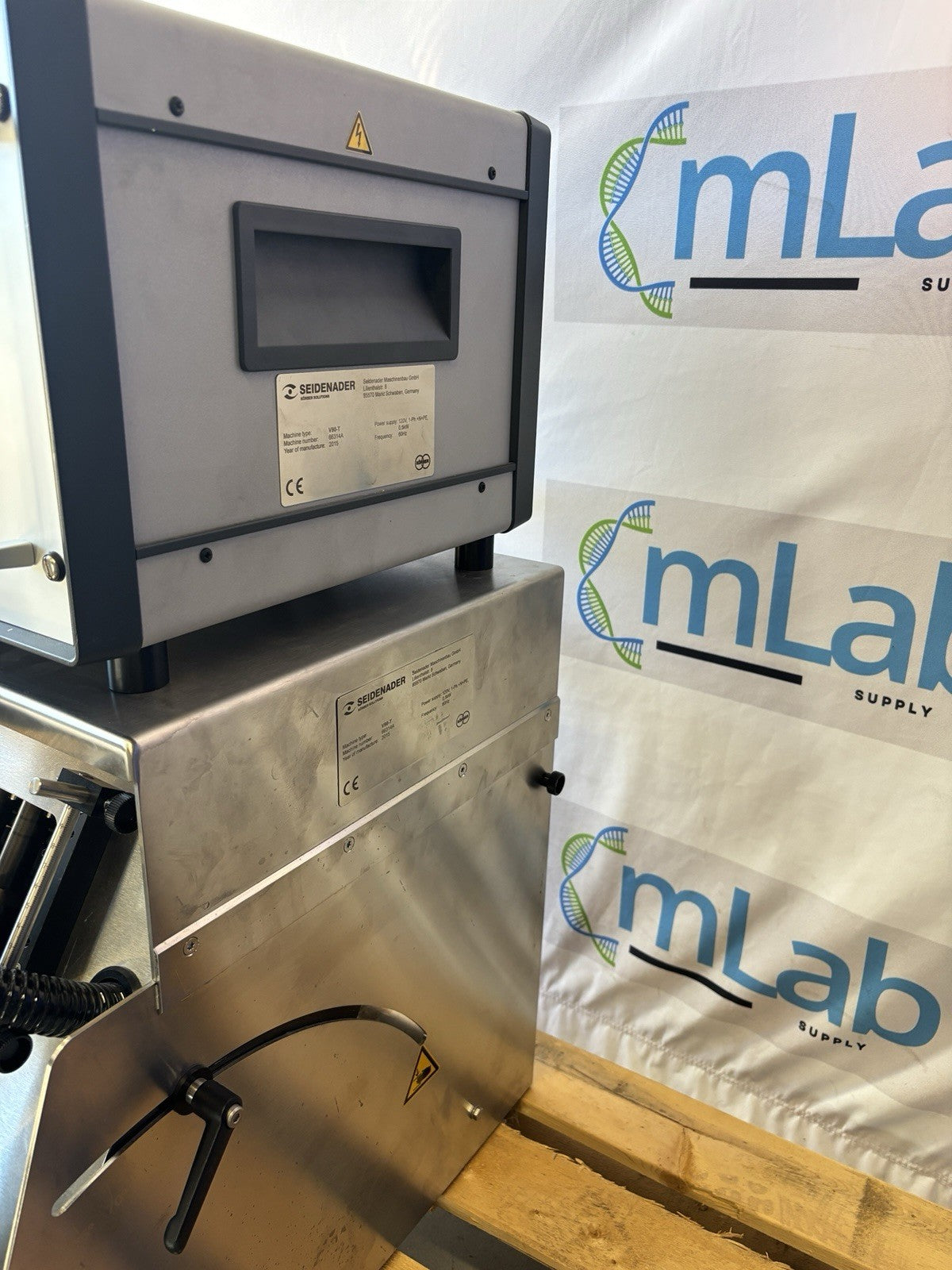 Stainless steel machine with 'mLab Supply' branding in the background